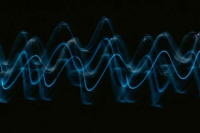 a black background with a blue wave of light
